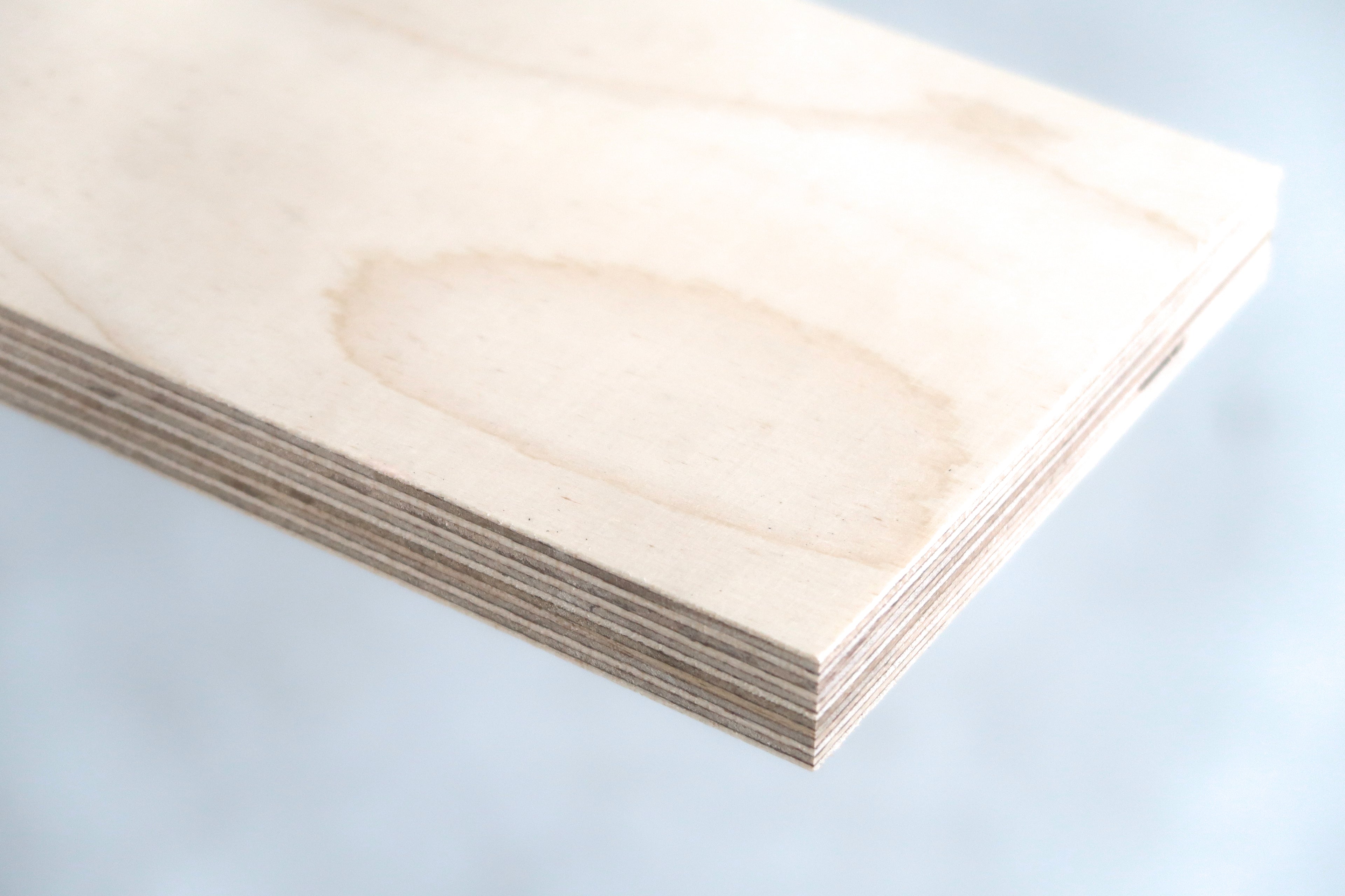 Close-up of a smooth, light wood plywood edge showcasing its robust, modular layered construction.