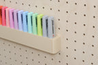 Close-up of the wall highlighter holder for pegboard with pastel highlighters - Aire