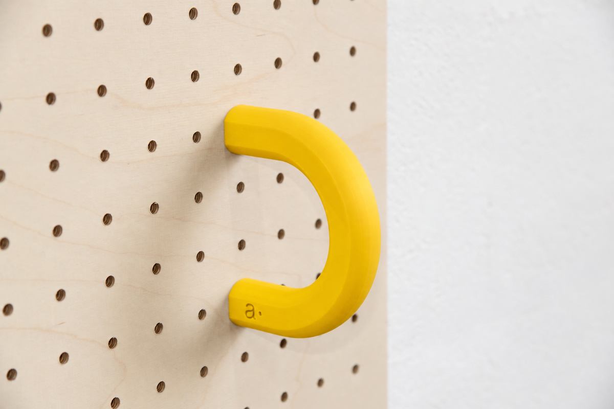 Anneau coloré jaune taille L sur un pegboard en bouleau