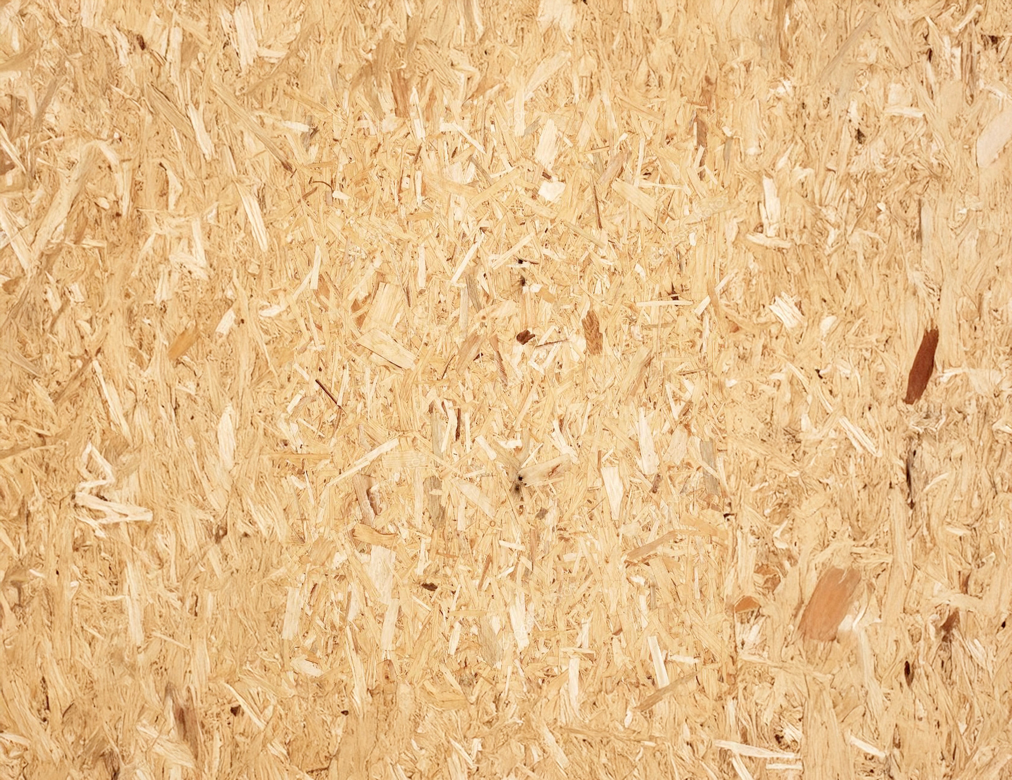 Close-up view of a natural wood chipboard surface showcasing a robust and modular texture pattern.