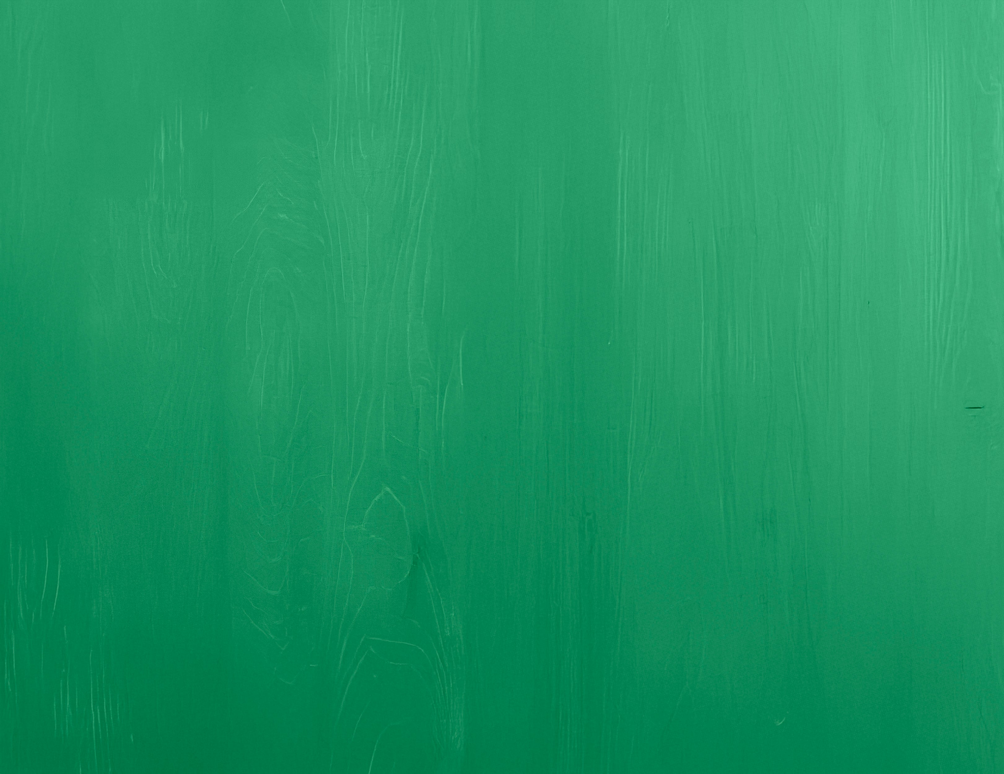 Smooth green wooden surface with subtle natural grain texture and an even finish across the panel