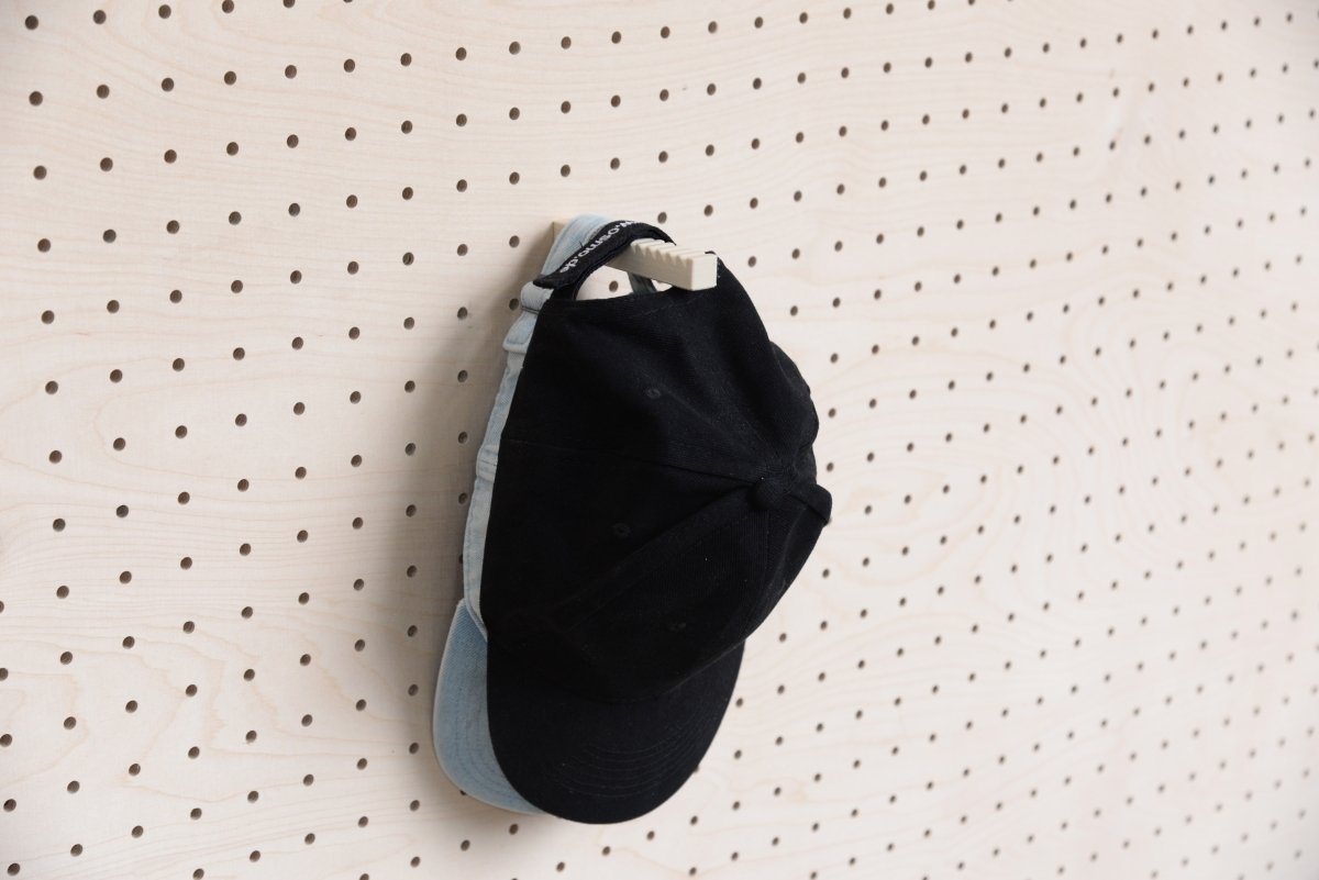 Two stacked caps on the Aire wall cap holder for pegboard